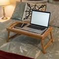 Rustic bamboo bed tray with stone mosaic inlay, portable and sturdy, ideal for breakfast or serving in a cozy bedroom setting.
