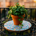 Handcrafted round rainbow mosaic plant stand with colorful glass tiles, ideal for displaying potted plants indoors or outdoors.
