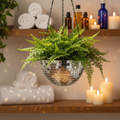 Hanging disco ball planter by Miss Bette's Creations with artificial pink carnations and reflective surface for decorative display.