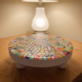 White rainbow mosaic plant stand with handcrafted design, featuring colorful tiled pattern and sturdy metal frame.