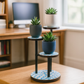 Three-tier mosaic multi-level plant stand with colorful ceramic pots and sturdy metal frame for indoor or outdoor use.