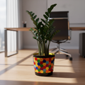 Colorful flower bouquet in a rainbow mosaic hexagon planter, showcasing vibrant blooms and decorative plant container.