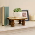 Vintage hand-carved wooden pedestal stand with intricate designs, perfect for displaying decorative items or sculptures.