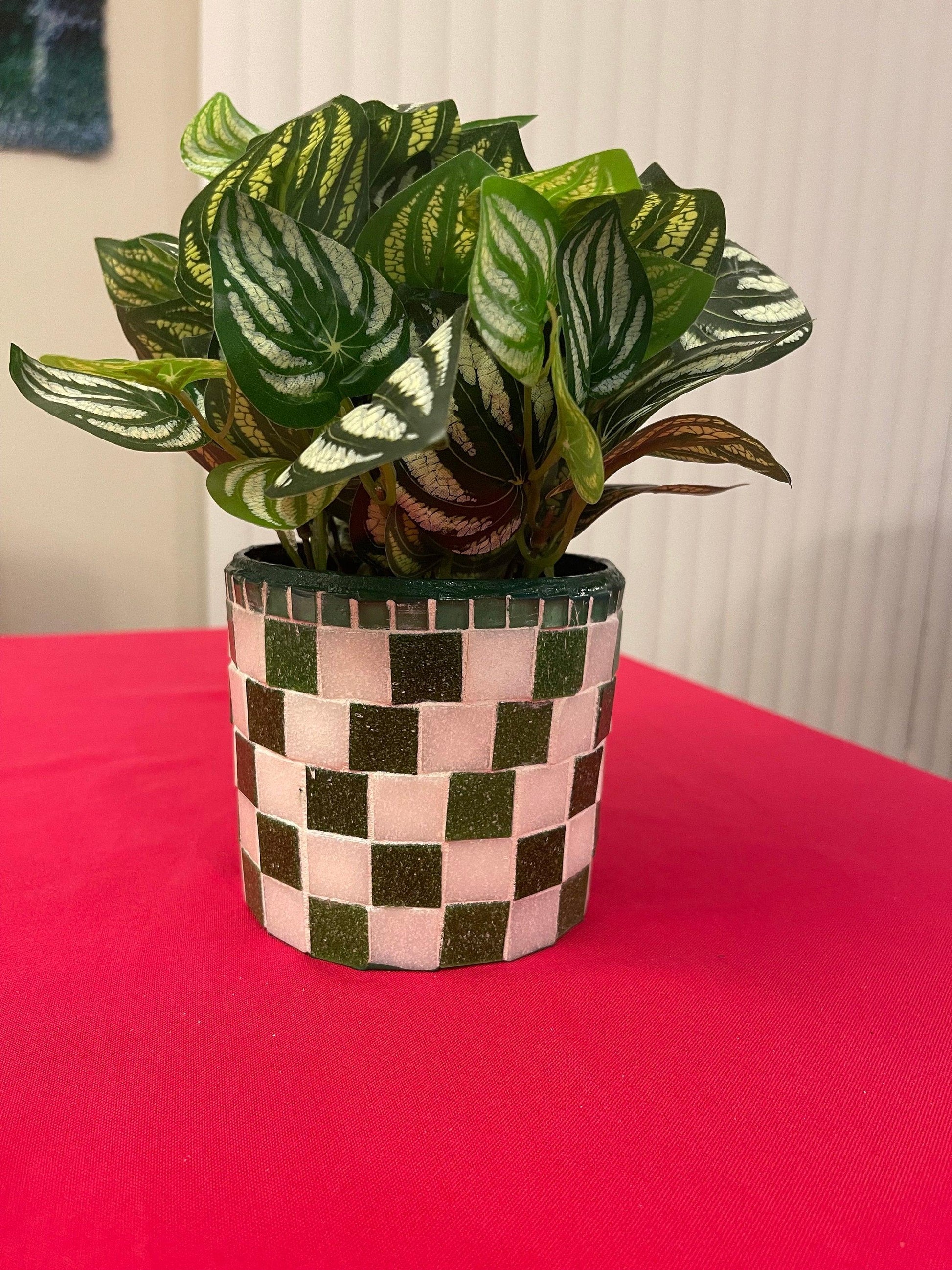 Modern green and white checkerboard mosaic herb planter with a round shape and vibrant design.