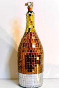 Luxury gold mosaic wine decanter with intricate gold pattern, clear glass body, and elegant design for serving wine.