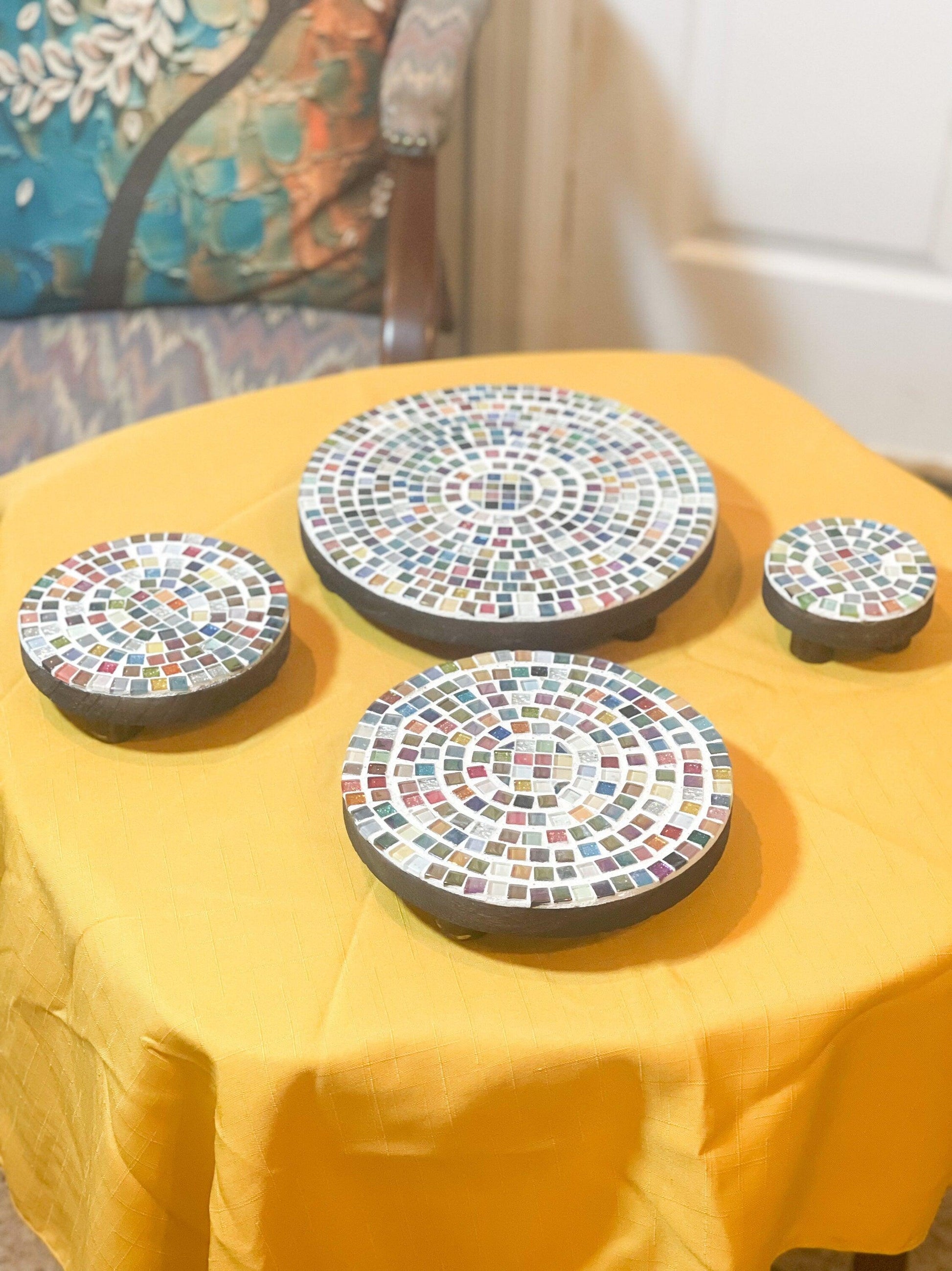 Handcrafted 4-tier mosaic plant stand set with colorful ceramic tiles, perfect for displaying indoor or outdoor plants.
