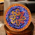 Decorative mid-century modern mosaic plate with colorful geometric patterns on a white background.