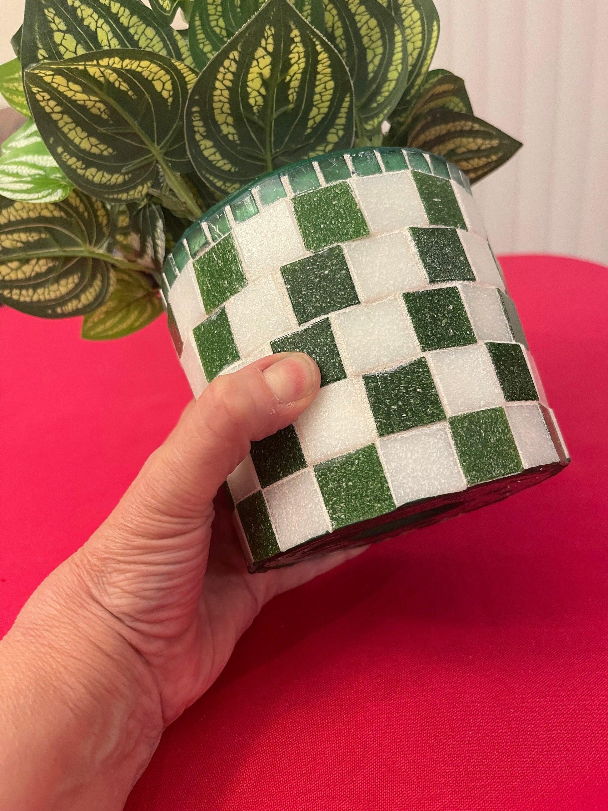 Modern green and white checkerboard mosaic herb planter with a round shape and lush herbs inside.