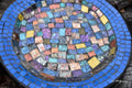 Iridescent blue glass mosaic wall art featuring vibrant, shimmering tiles arranged in an eye-catching design.