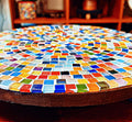 Handcrafted round rainbow mosaic plant stand with colorful tile design, sturdy base, perfect for indoor or outdoor plants.