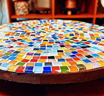 Handcrafted round rainbow mosaic plant stand with colorful tile design, sturdy base, perfect for indoor or outdoor plants.