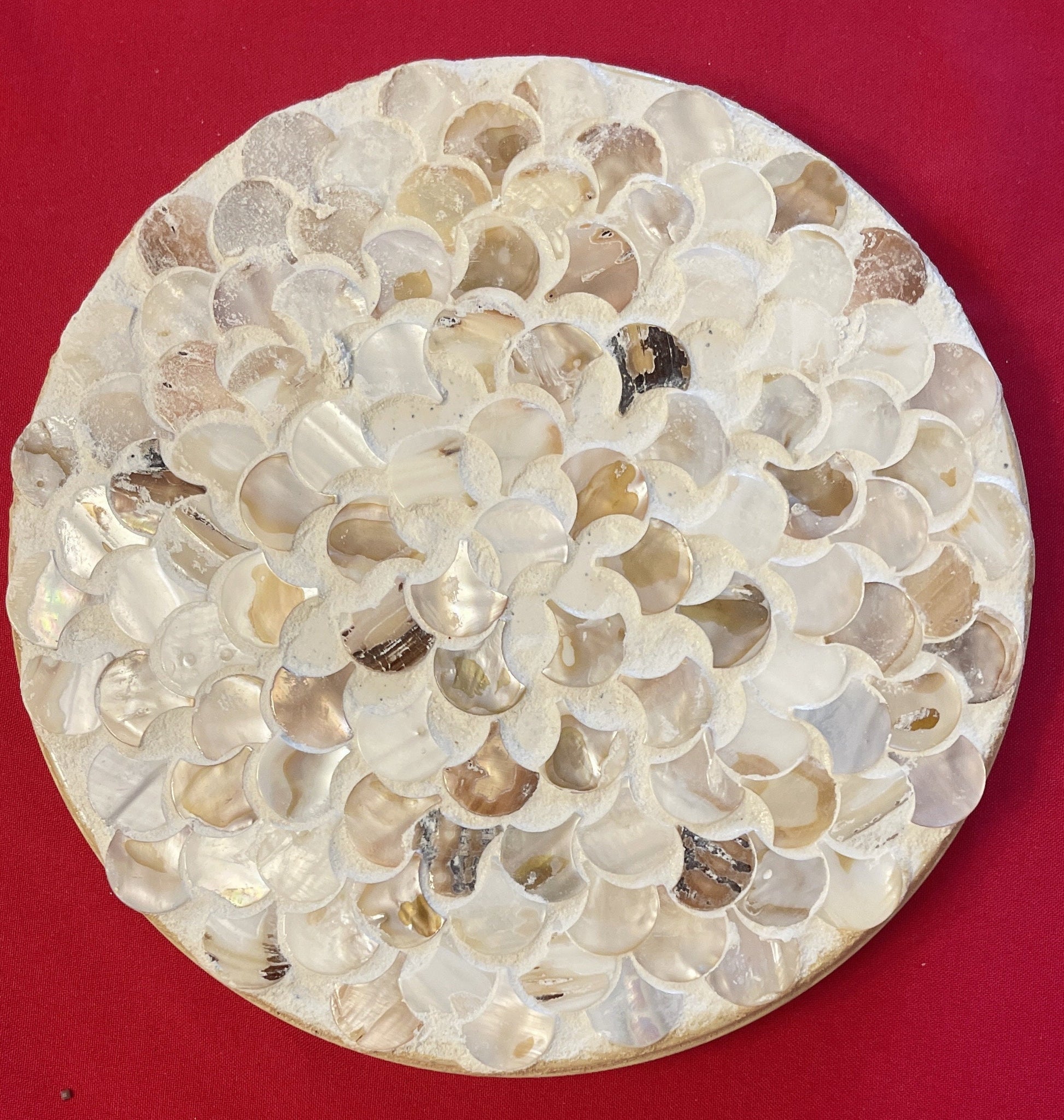 Handmade mother of pearl scallop mosaic decorative stand with intricate shell pattern and elegant design.