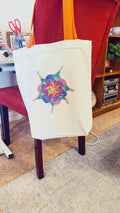Handmade sparkling starburst diamond art canvas tote bag with colorful design and sturdy handles.
