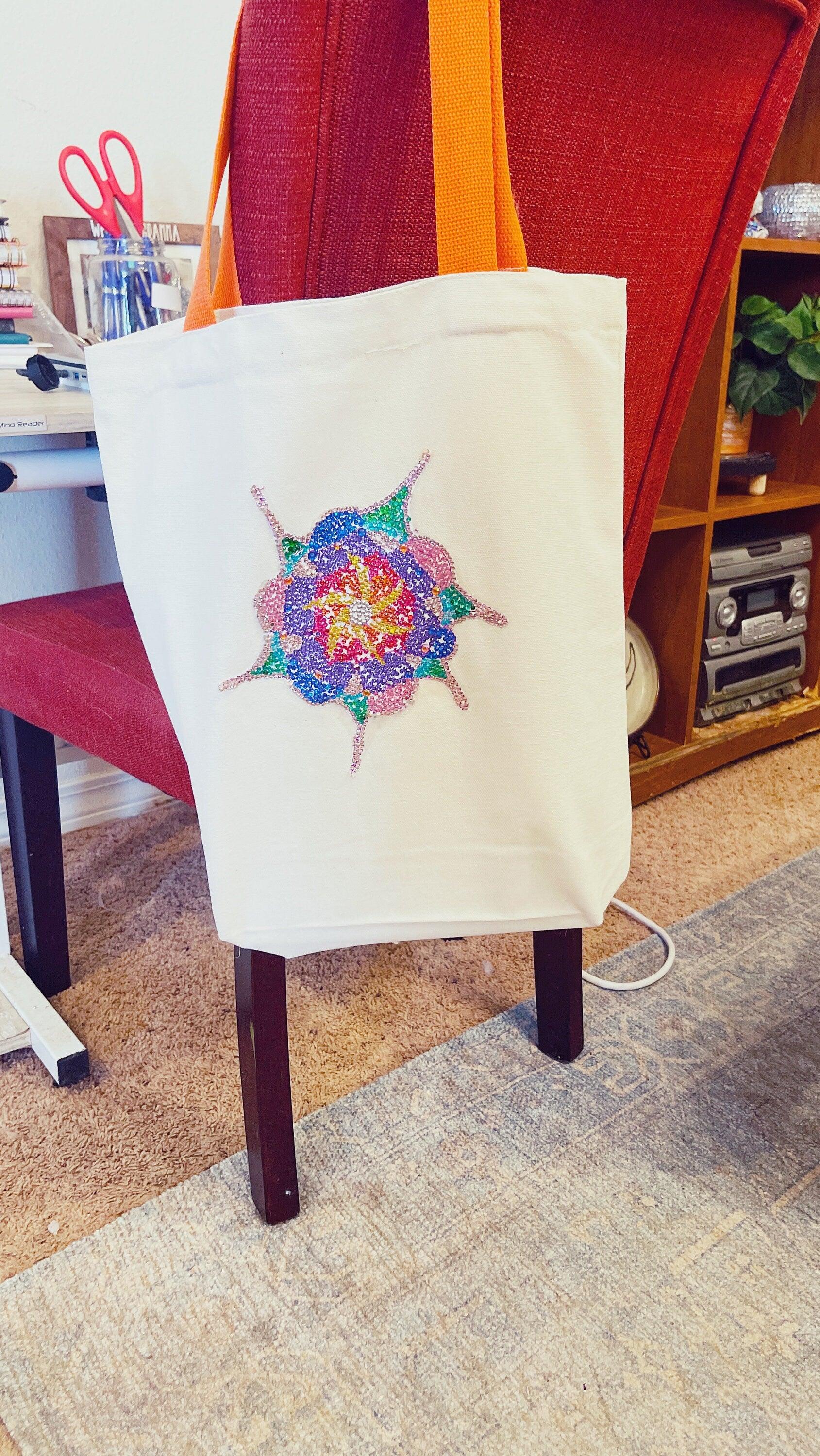 Handmade sparkling starburst diamond art canvas tote bag with colorful design and sturdy handles.