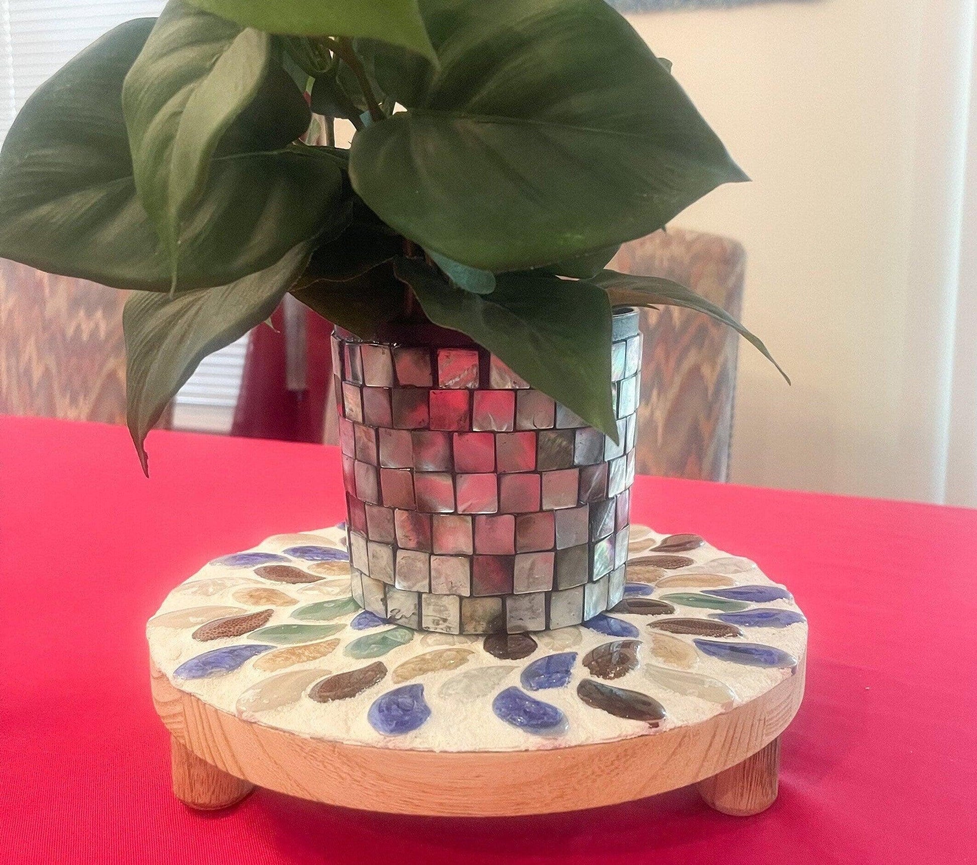Handmade earth tone mosaic plant stand with colorful tile design, perfect for indoor or outdoor plants.