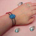Deep blue glass cuff bracelet with sleek design, featuring a wide band and smooth finish, perfect for stylish accessories.