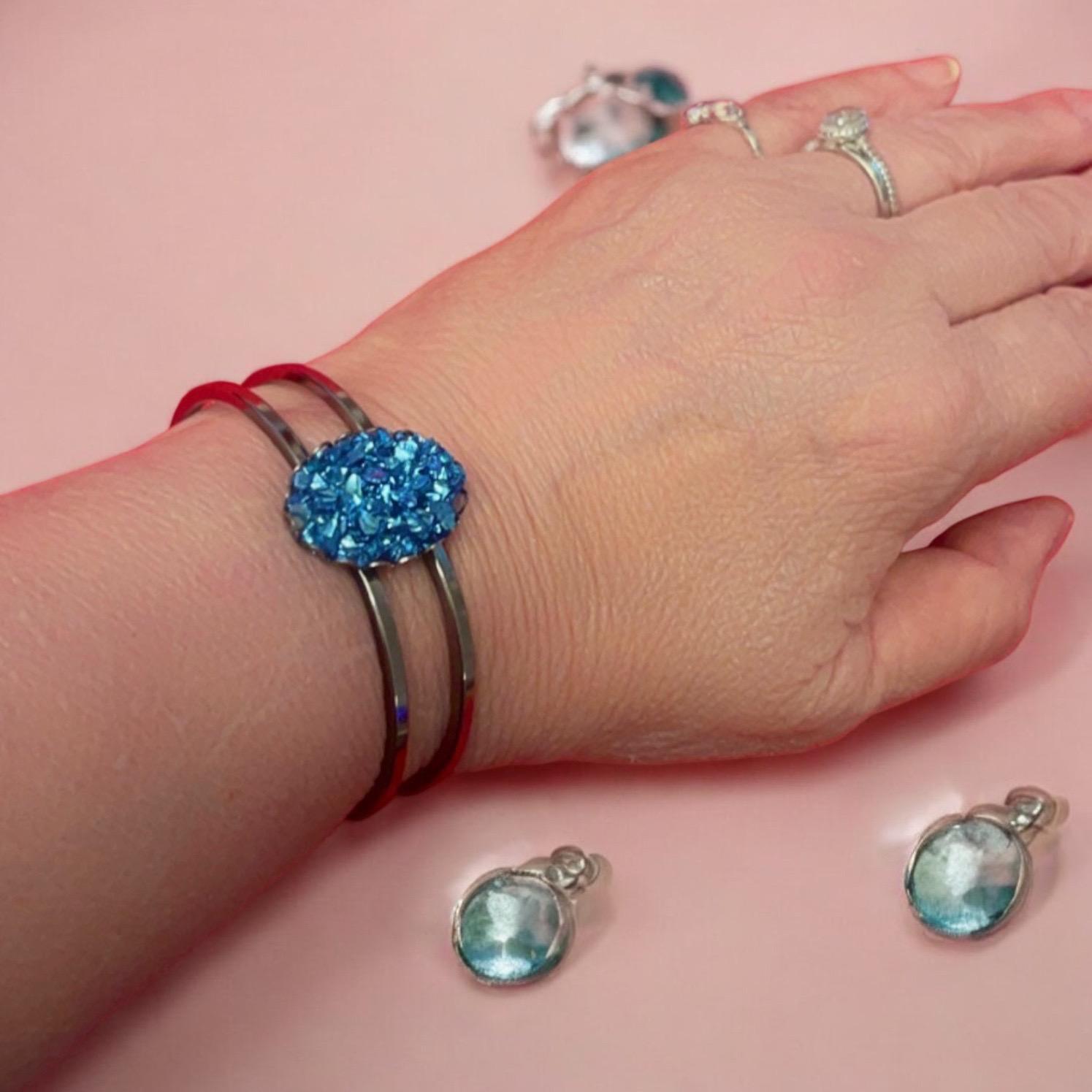 Deep blue glass cuff bracelet with sleek design, featuring a wide band and smooth finish, perfect for stylish accessories.