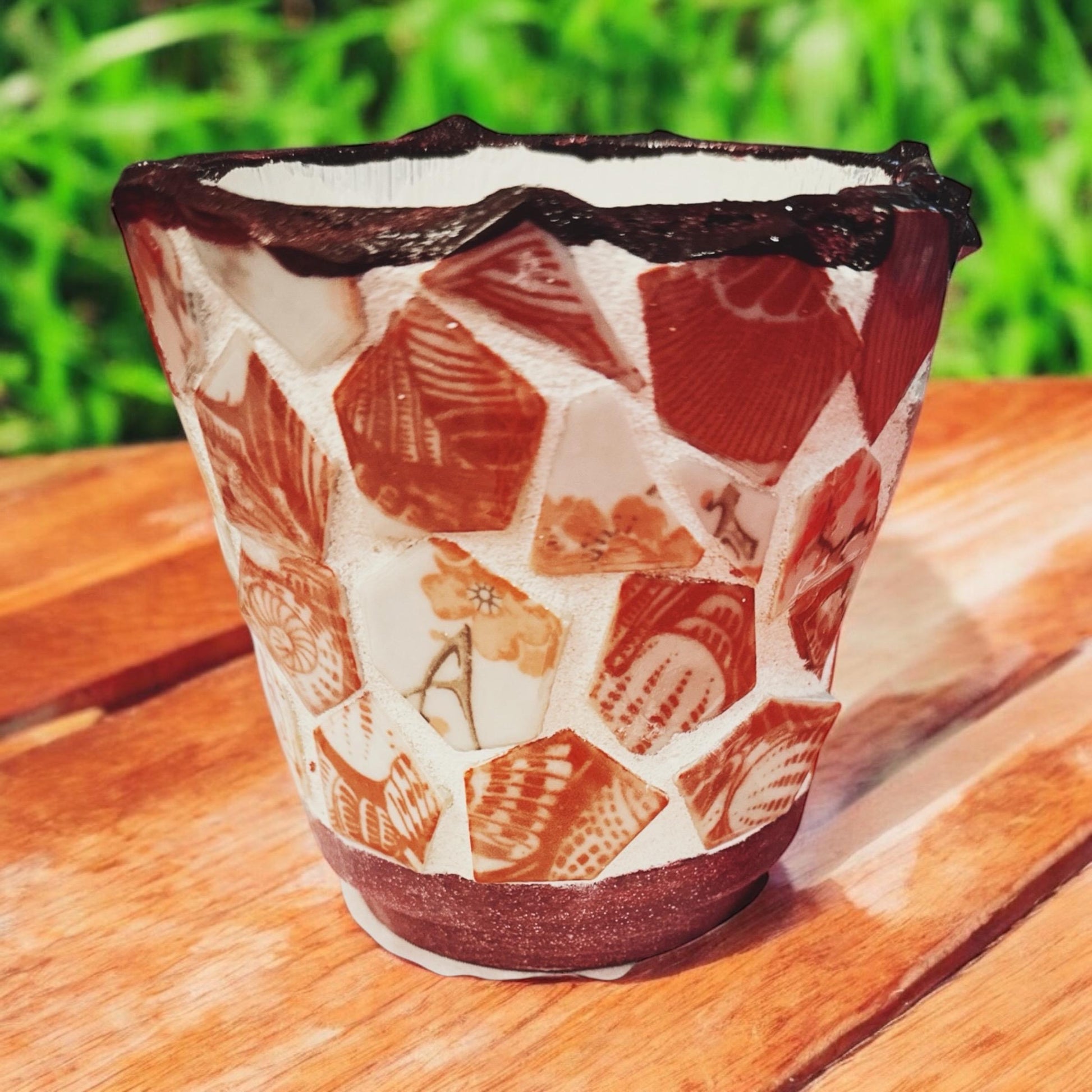 Colorful handcrafted broken china mosaic flower pot featuring vibrant floral patterns and a sturdy ceramic base.