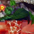 Handcrafted broken china mosaic flower pot with colorful floral design, showcasing vibrant mosaic patterns and rustic charm.