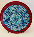 Deep crimson ceramic plate featuring Ocean Breeze mosaic design, showcasing vibrant blue and green ocean-inspired patterns.