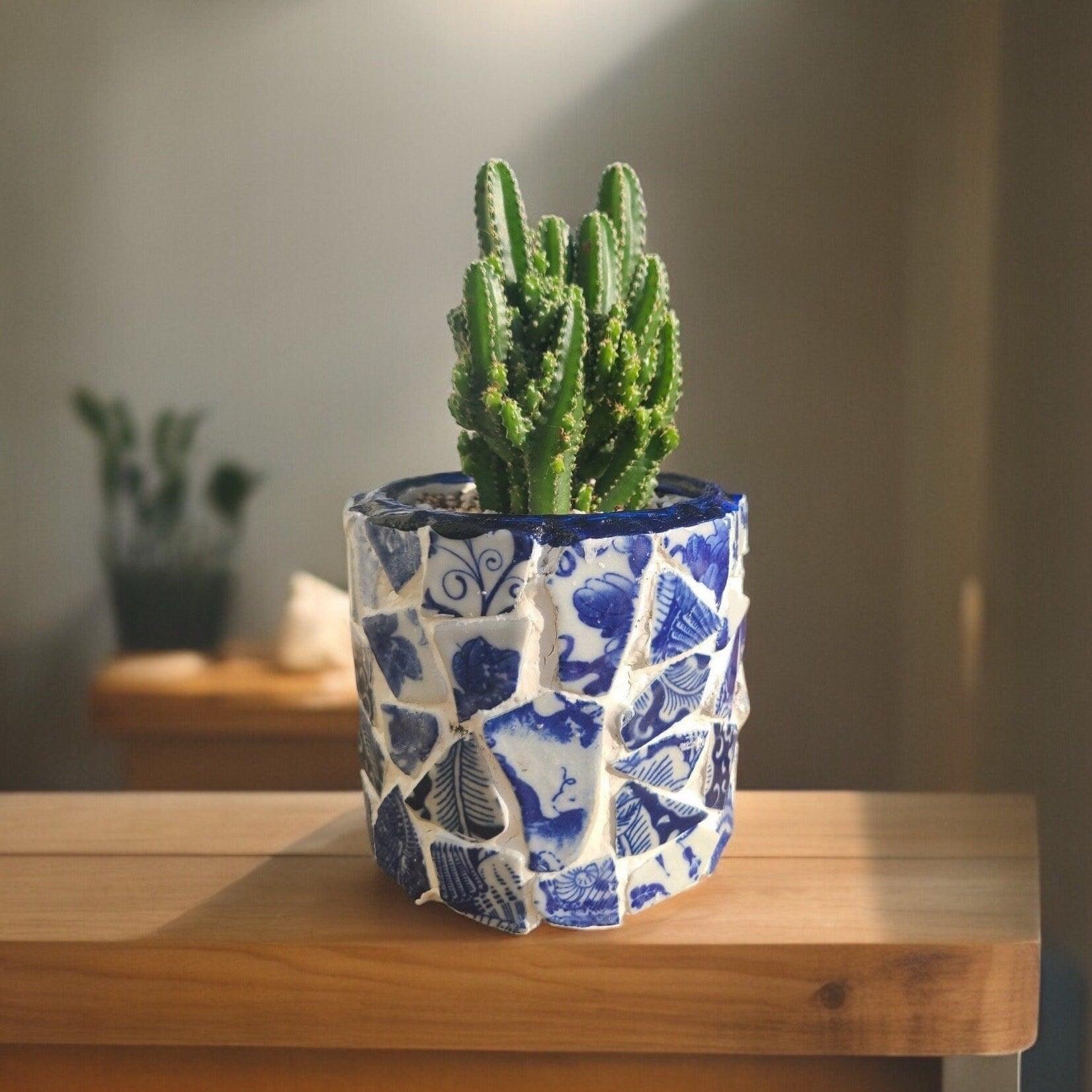 White broken china mosaic planter with intricate mosaic design, perfect for indoor or outdoor decorative plant displays.