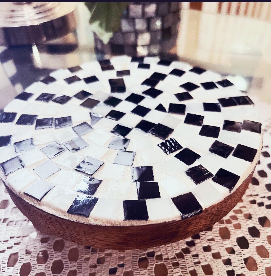 Handmade black and white checkered mosaic plant stand with a sturdy base and decorative pattern, perfect for indoor or outdoor plants.