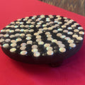 Handmade black and white iridescent mosaic plant stand with round top and decorative base, perfect for indoor plants.