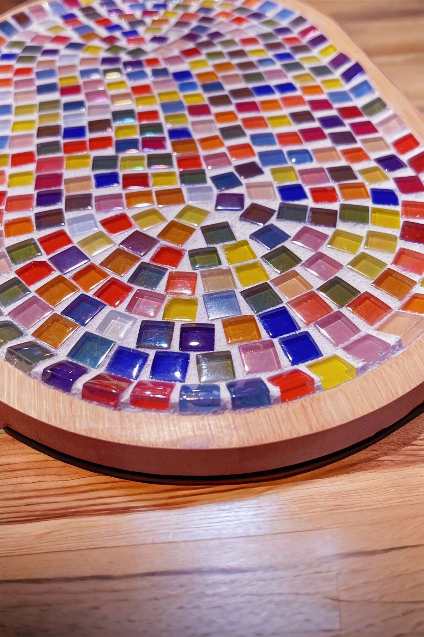 Handcrafted geometric star mosaic wall art featuring colorful ceramic tiles on a white background.