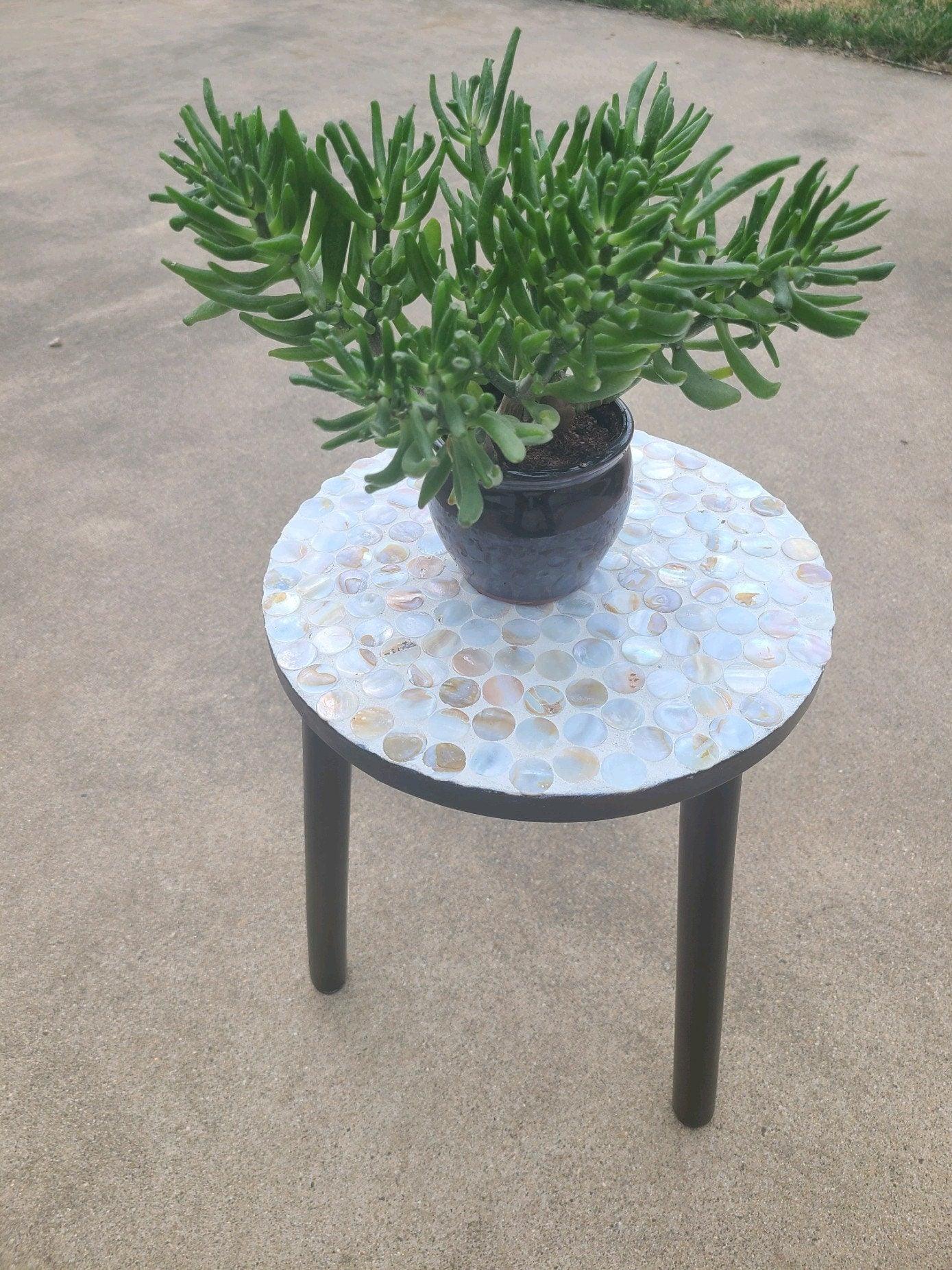 Tall Capiz shell mosaic plant stand with round top and decorative base, ideal for displaying potted plants in elegant home decor.