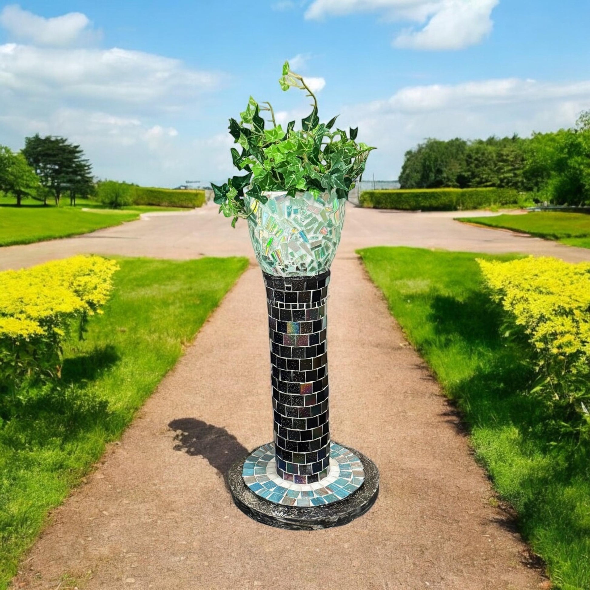 Colorful handcrafted mosaic pedestal planter with intricate tile design, perfect for indoor or outdoor decorative plants.