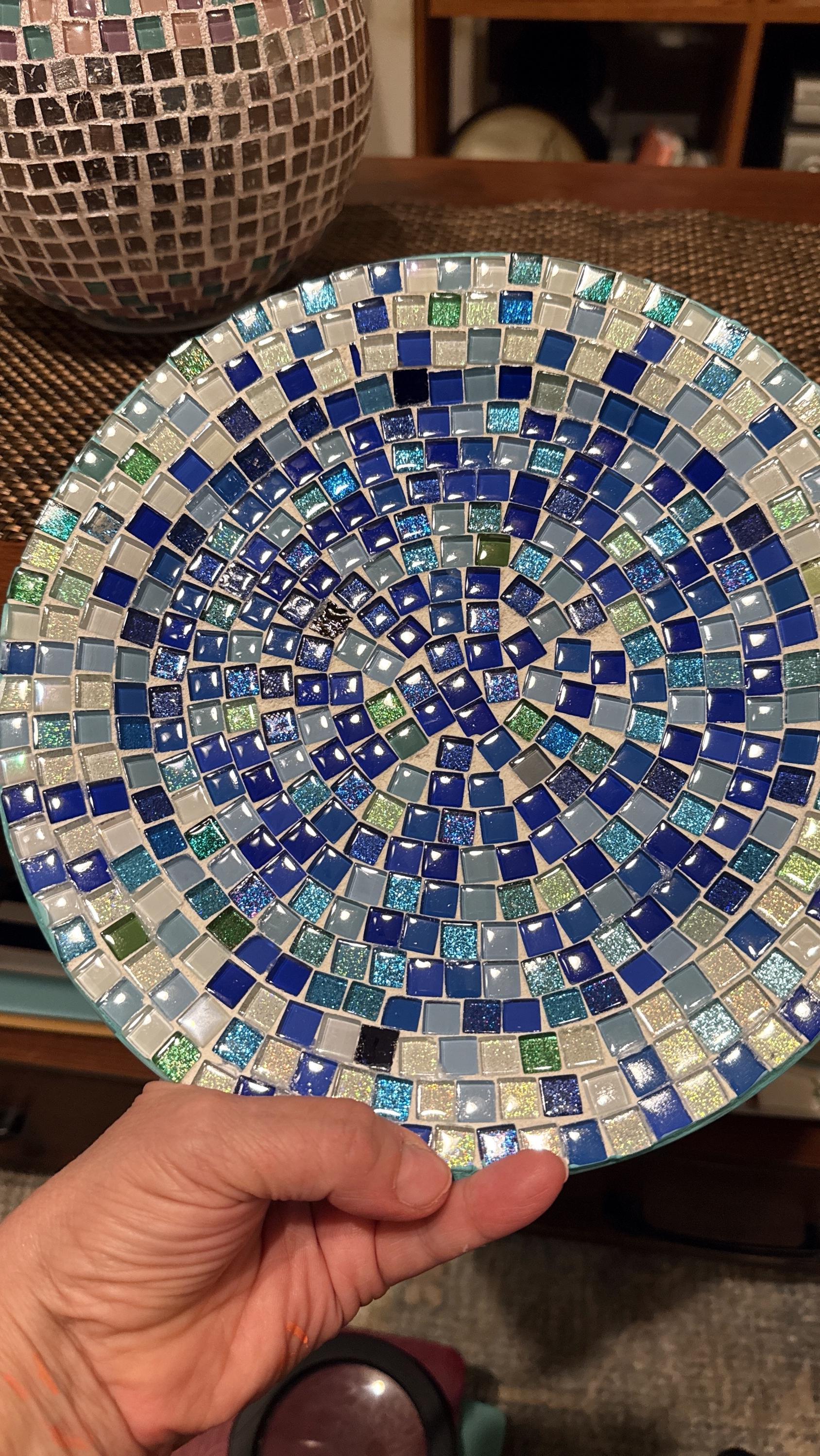 Ocean blue and emerald green mosaic glass plate with intricate pattern, showcasing vibrant colors and textured glass surface.