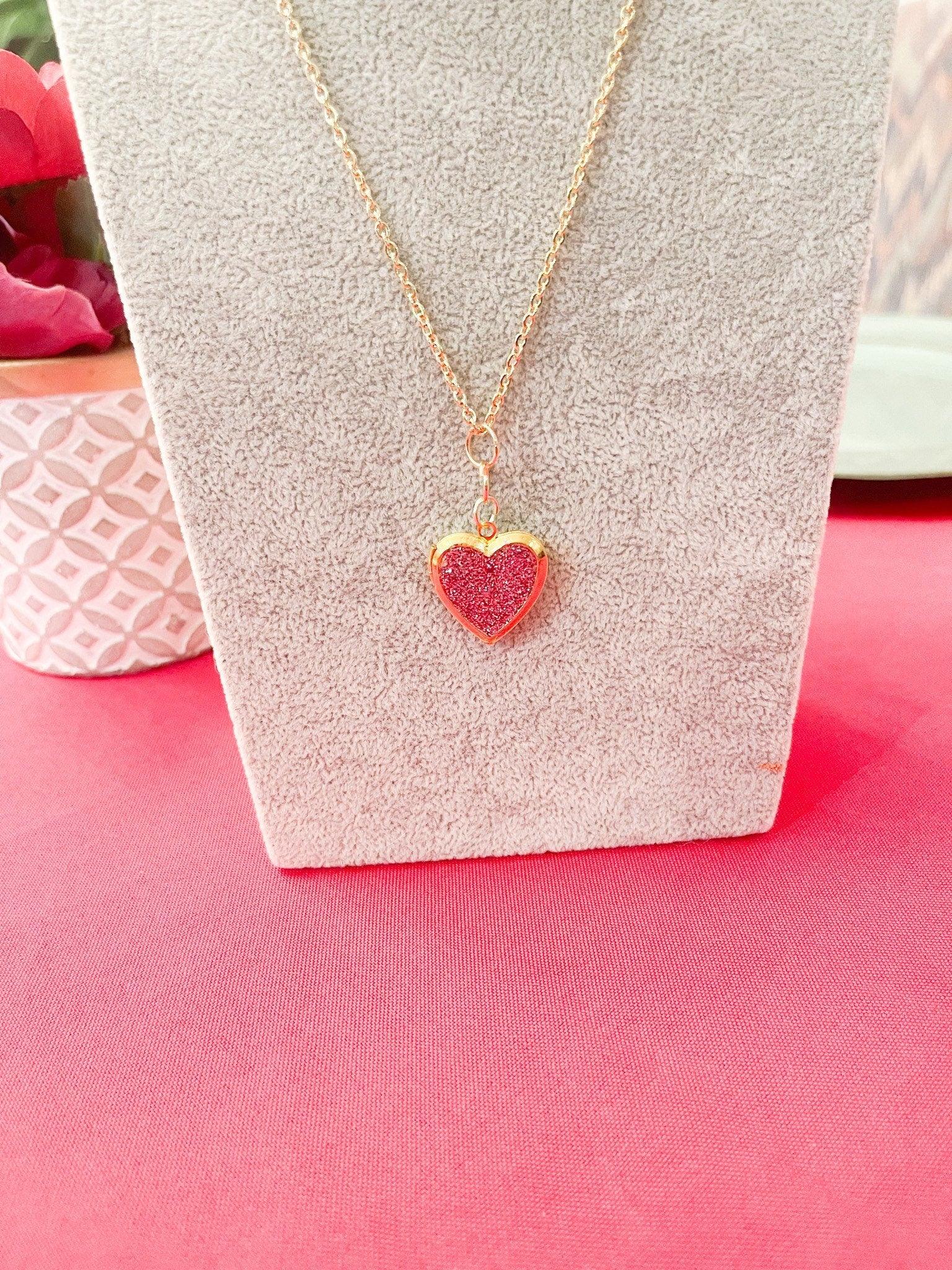 Gold sparkling rose-shaped heart locket with intricate detailing, perfect for romantic jewelry collection.