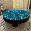 Artisanal turquoise cabochon mosaic plant stand by Miss Bette's Creations, featuring vibrant mosaic tile design and sturdy structure.