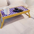 Handcrafted bamboo laptop tray with pink cushion for comfortable working or lounging.