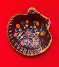 Hand painted ceramic ring dish featuring colorful floral designs, perfect for jewelry organization and decorative use.