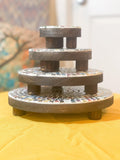 Handcrafted 4-tier mosaic plant stand set with colorful tile designs, perfect for displaying potted plants indoors or outdoors.