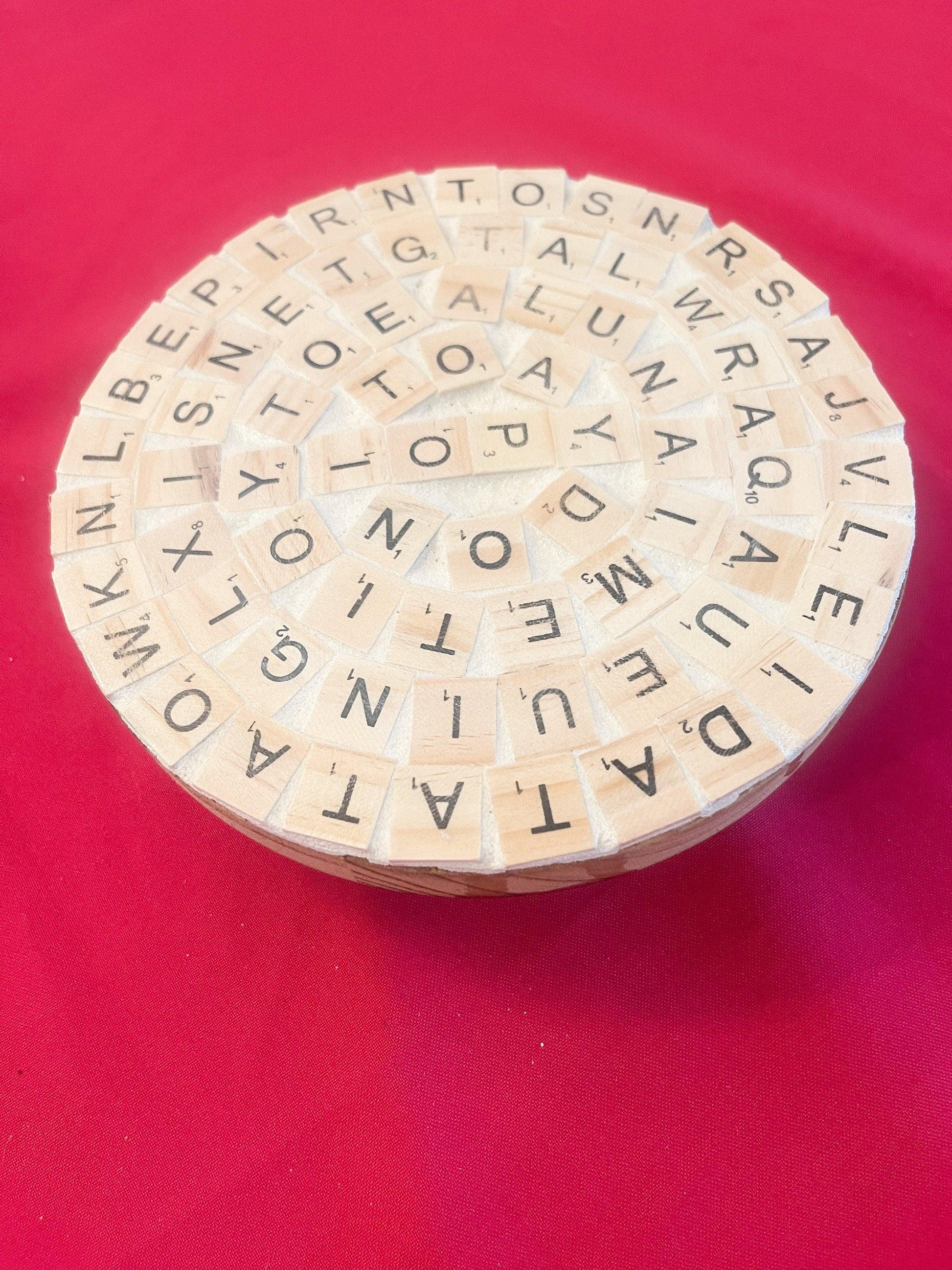 Decorative plant stand with a word game design, perfect for displaying small plants or succulents in a stylish home decor setting.