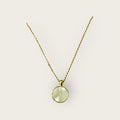 Iridescent shell resin circle pendant, showcasing a shimmering, colorful jewelry piece with a smooth, rounded shape.