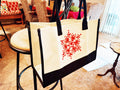 Large white and red custom canvas bag with handles, featuring a bold design, ideal for casual or shopping use.