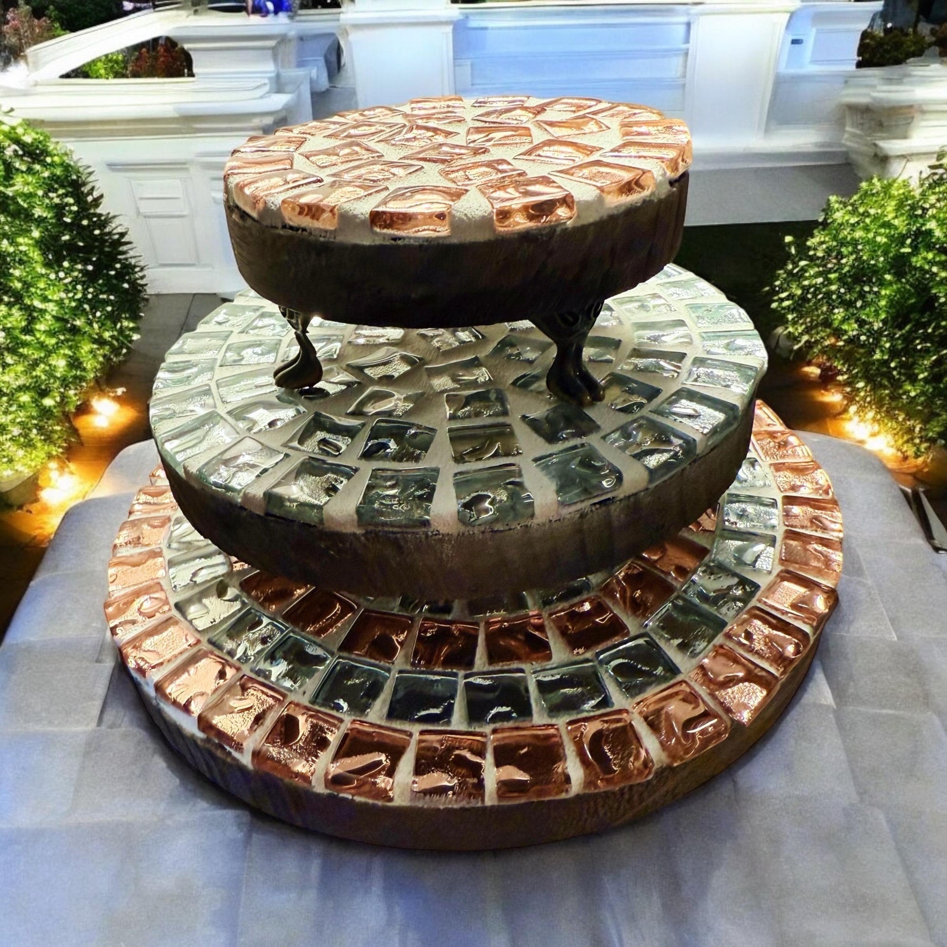 Handcrafted metallic mosaic plant stand set featuring intricate patterns and multiple tiers for displaying potted plants.