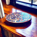 10-inch handcrafted rainbow mosaic plant stand by Miss Bette's Creations with colorful tiled surface and sturdy metal legs.