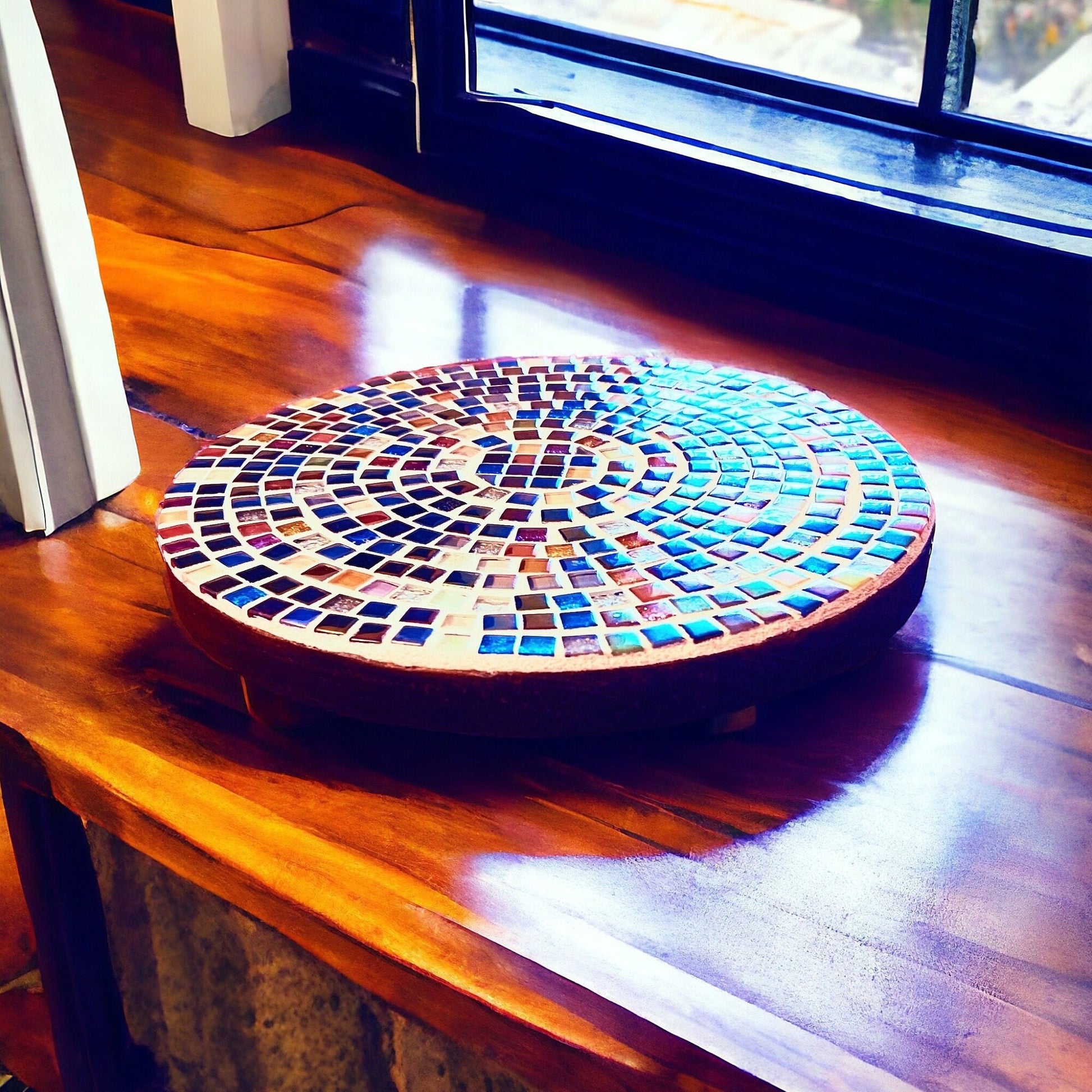 10-inch handcrafted rainbow mosaic plant stand by Miss Bette's Creations with colorful tiled surface and sturdy metal legs.