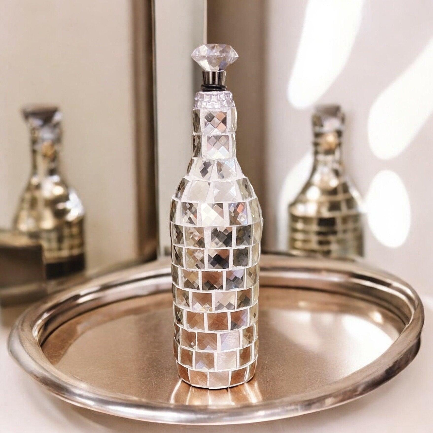 Silver mirrored mosaic wine decanter with intricate mosaic design, elegant shape, and reflective surface, perfect for wine serving.