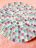 Handcrafted pink and green mosaic plant stand by Miss Bette's Creations with intricate tile patterns and sturdy wooden legs