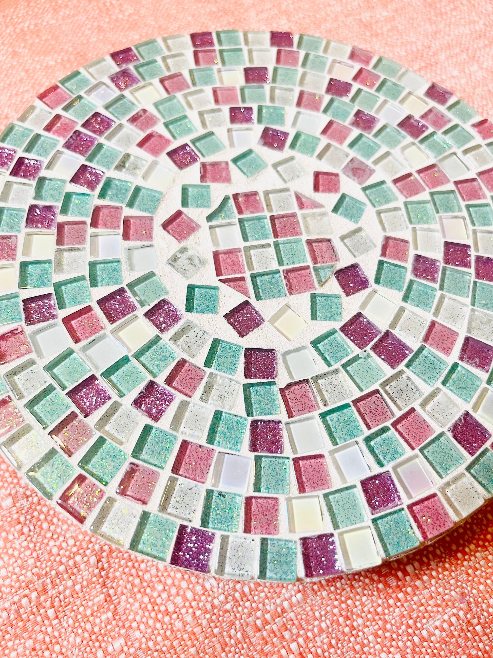 Handcrafted pink and green mosaic plant stand by Miss Bette's Creations with intricate tile patterns and sturdy wooden legs