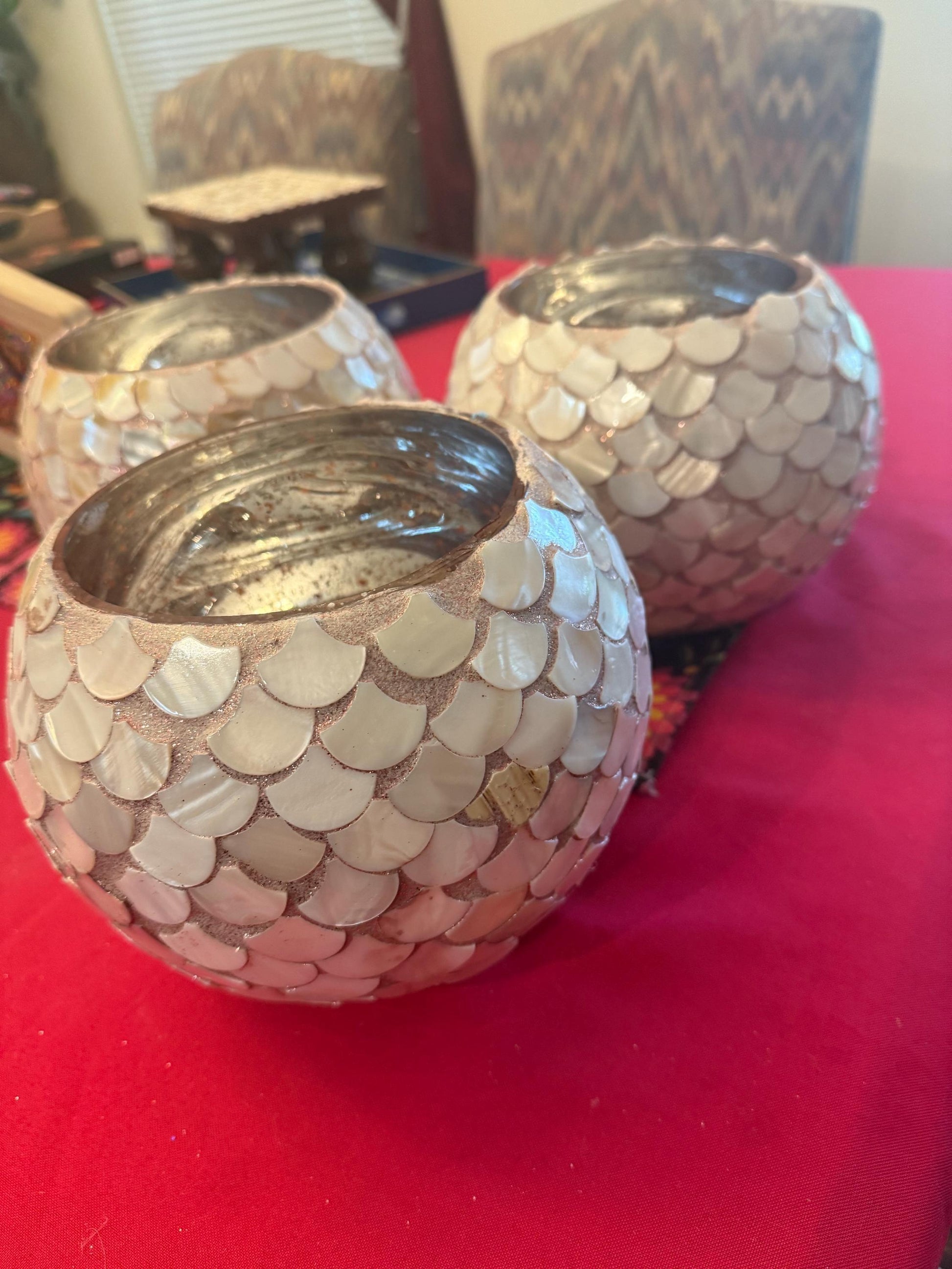 Handcrafted scalloped Capiz shell globe vase with intricate shell details, perfect for elegant home decor.