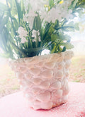 Handcrafted seashell mosaic plant pot with colorful shell patterns, perfect for indoor or outdoor decorative gardening.