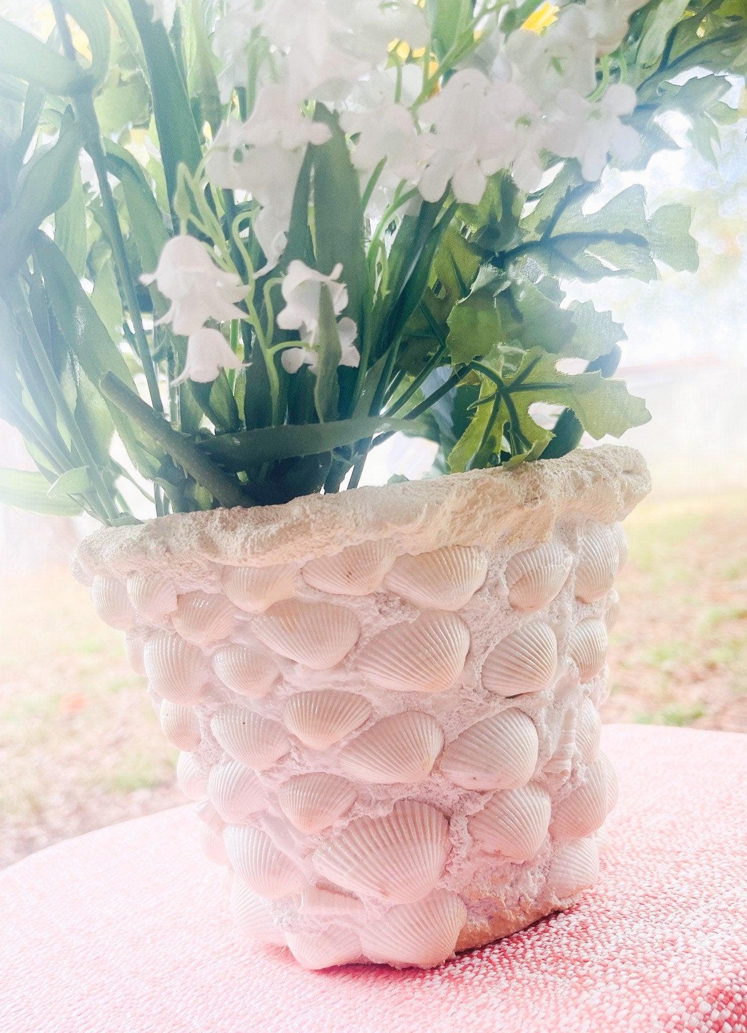 Handcrafted seashell mosaic plant pot with colorful shell patterns, perfect for indoor or outdoor decorative gardening.