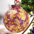 Rose and gold leaf Christmas ornament with intricate floral design, perfect for holiday decorating.