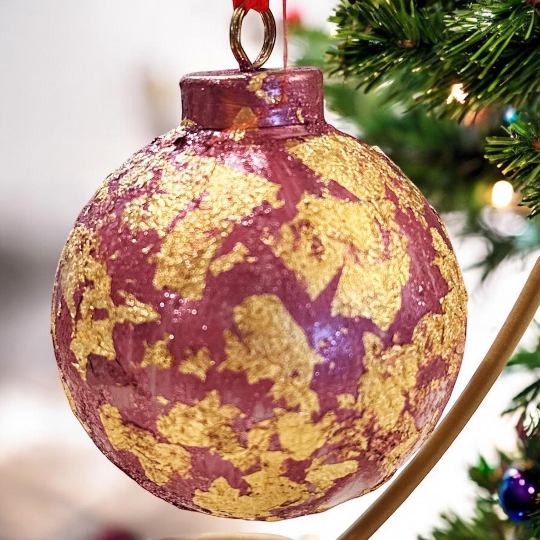 Rose and gold leaf Christmas ornament with intricate floral design, perfect for holiday decorating.